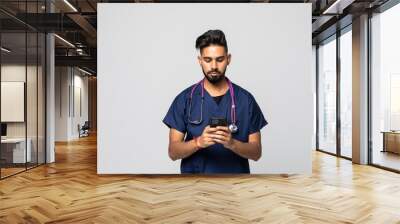 Photo of young doctor using his smartphone white background Wall mural